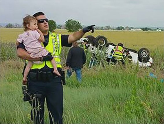 Video: Heartbreaking photo shows cop singing to little girl after father dies in car crash